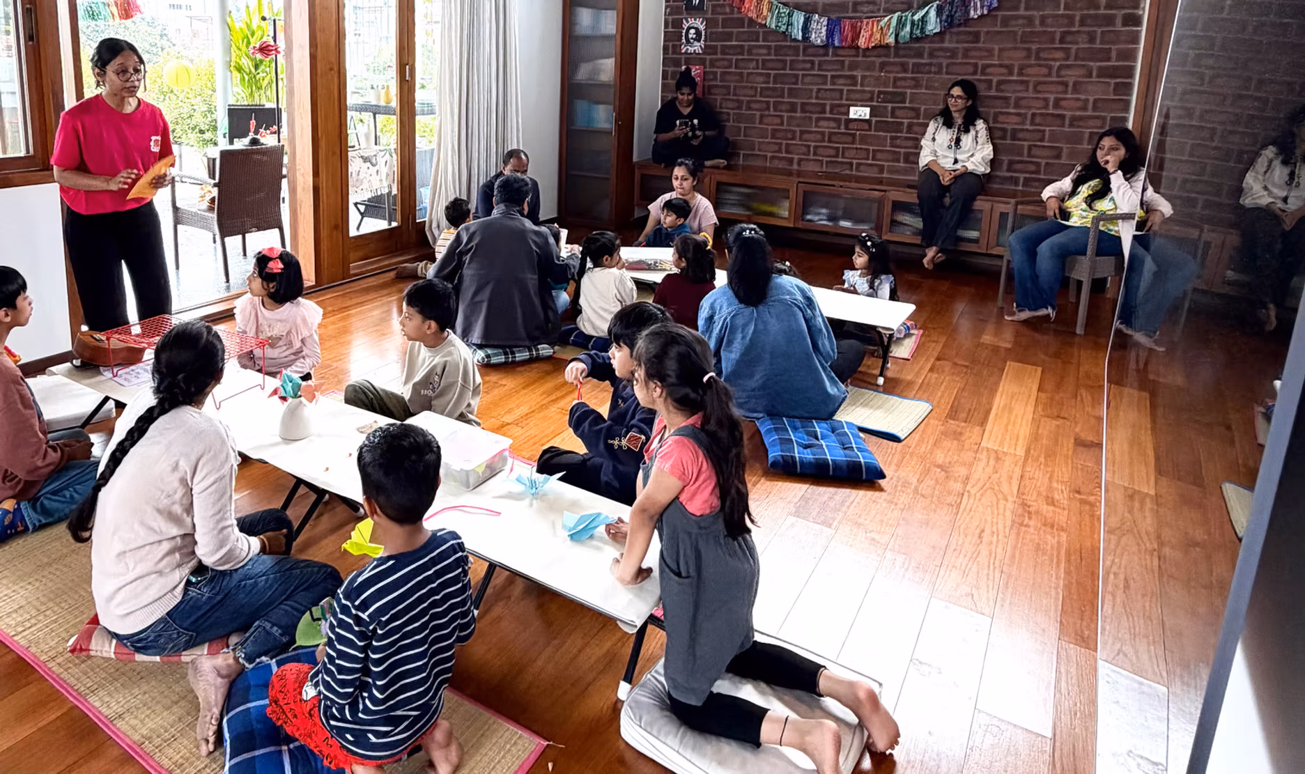 A workshop in full swing at Sanctuary, tables covered in materials, everyone mid-project